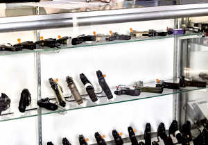 51222521 - rows of guns for sale in showcase of retail store with application on counter